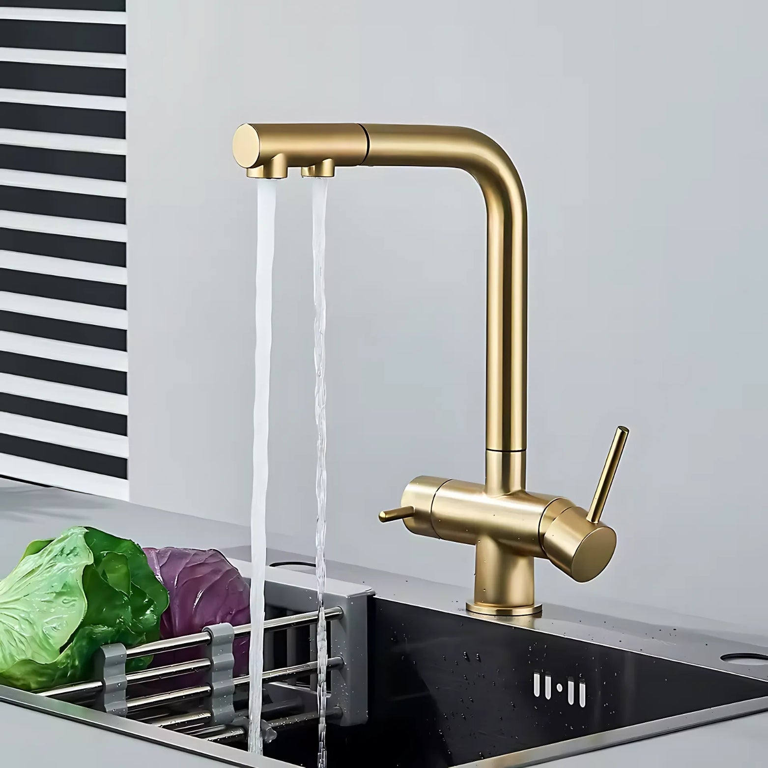 3-Way Pull-Out Gold kitchen faucet with water flowing into a sink, with vegetables nearby.