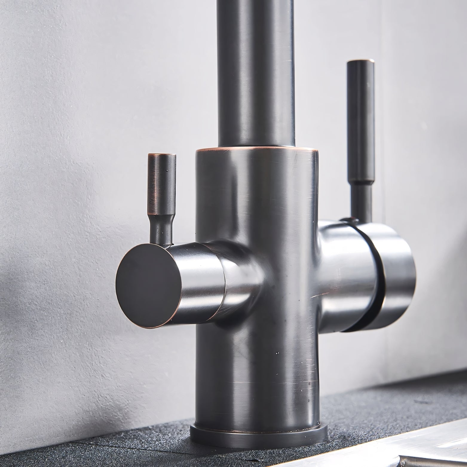 Modern kitchen faucet with multiple handles on a neutral background