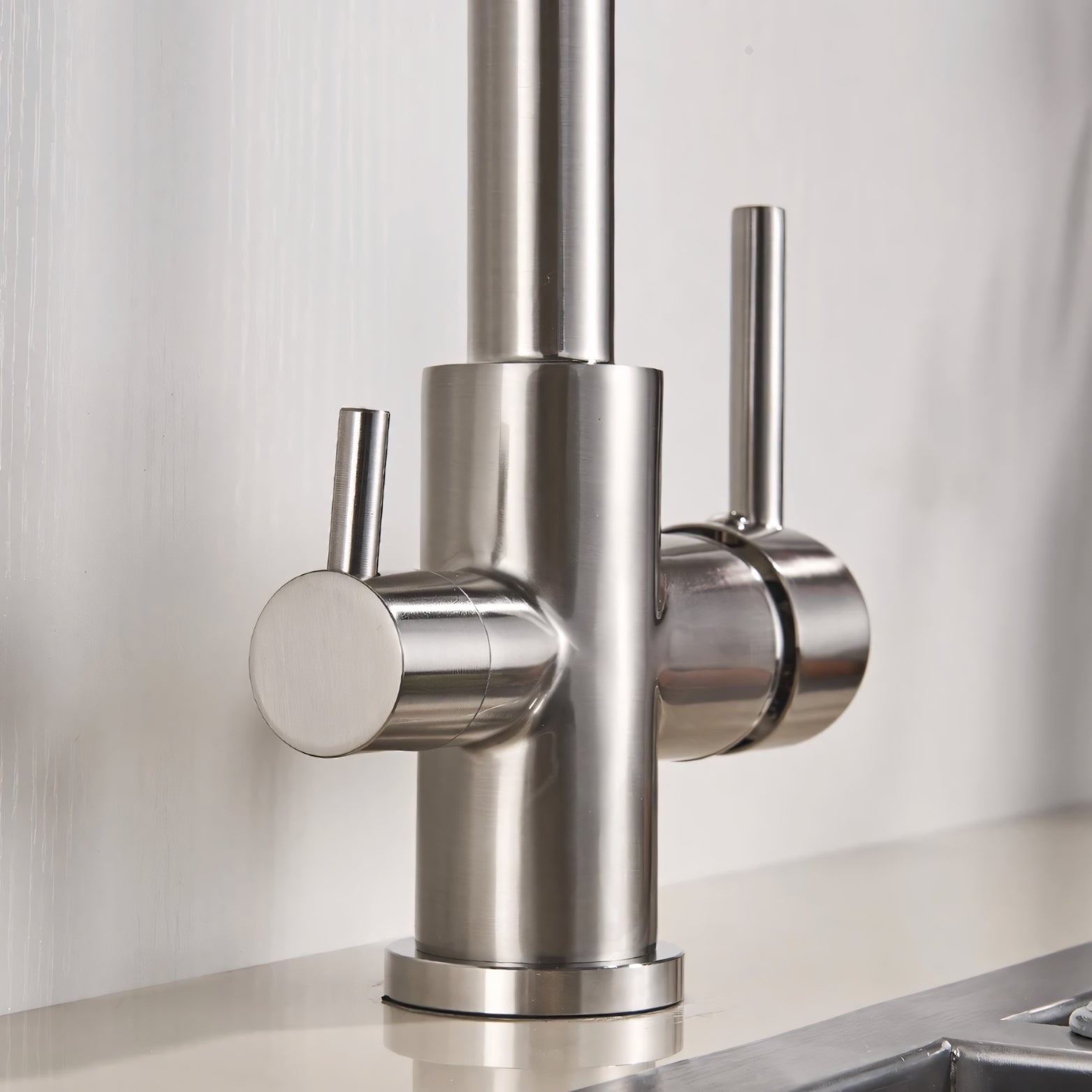 Stainless steel kitchen faucet on a white background