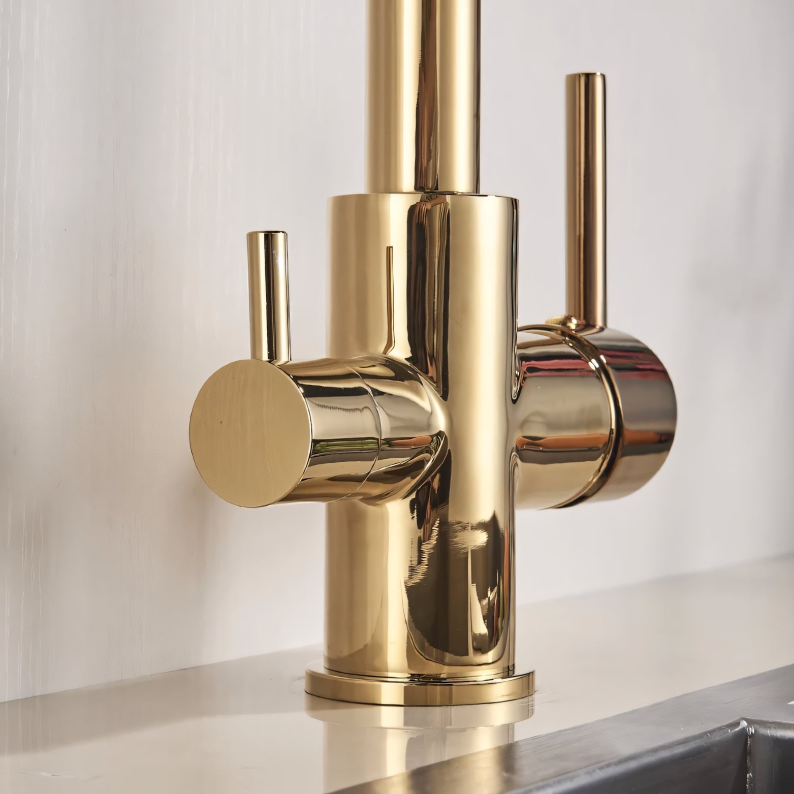 Gold kitchen faucet with multiple handles on a white background
