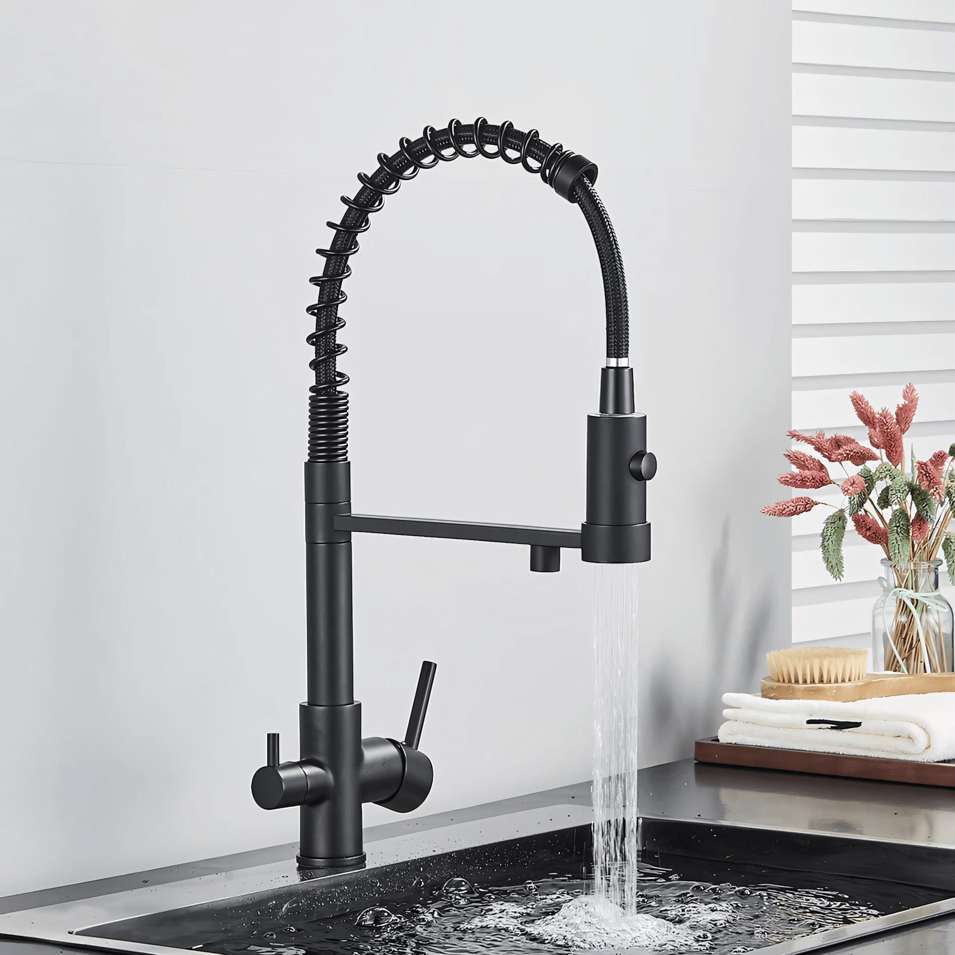 Black kitchen faucet with water flowing into a sink against a neutral background