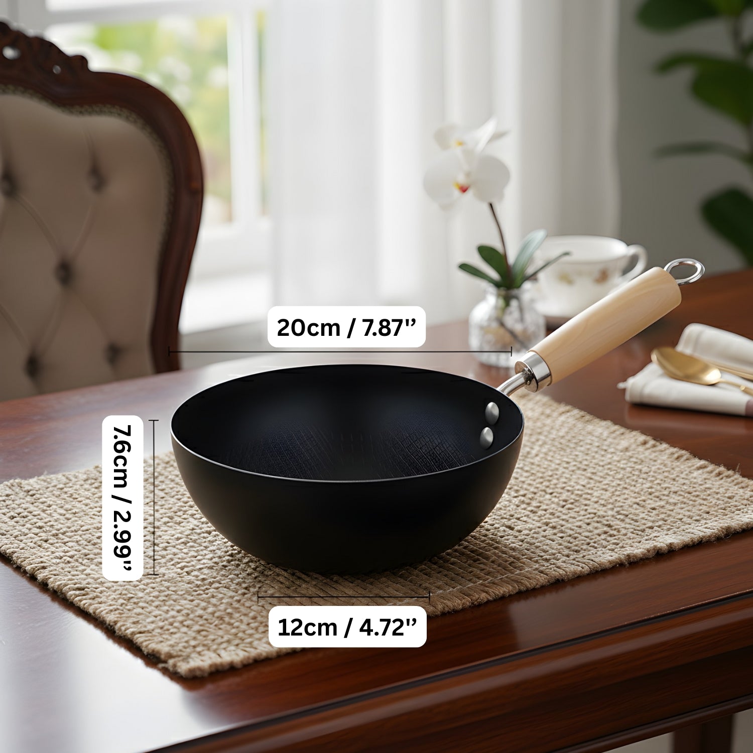 Black wok with wooden handle on a table with measurements displayed
