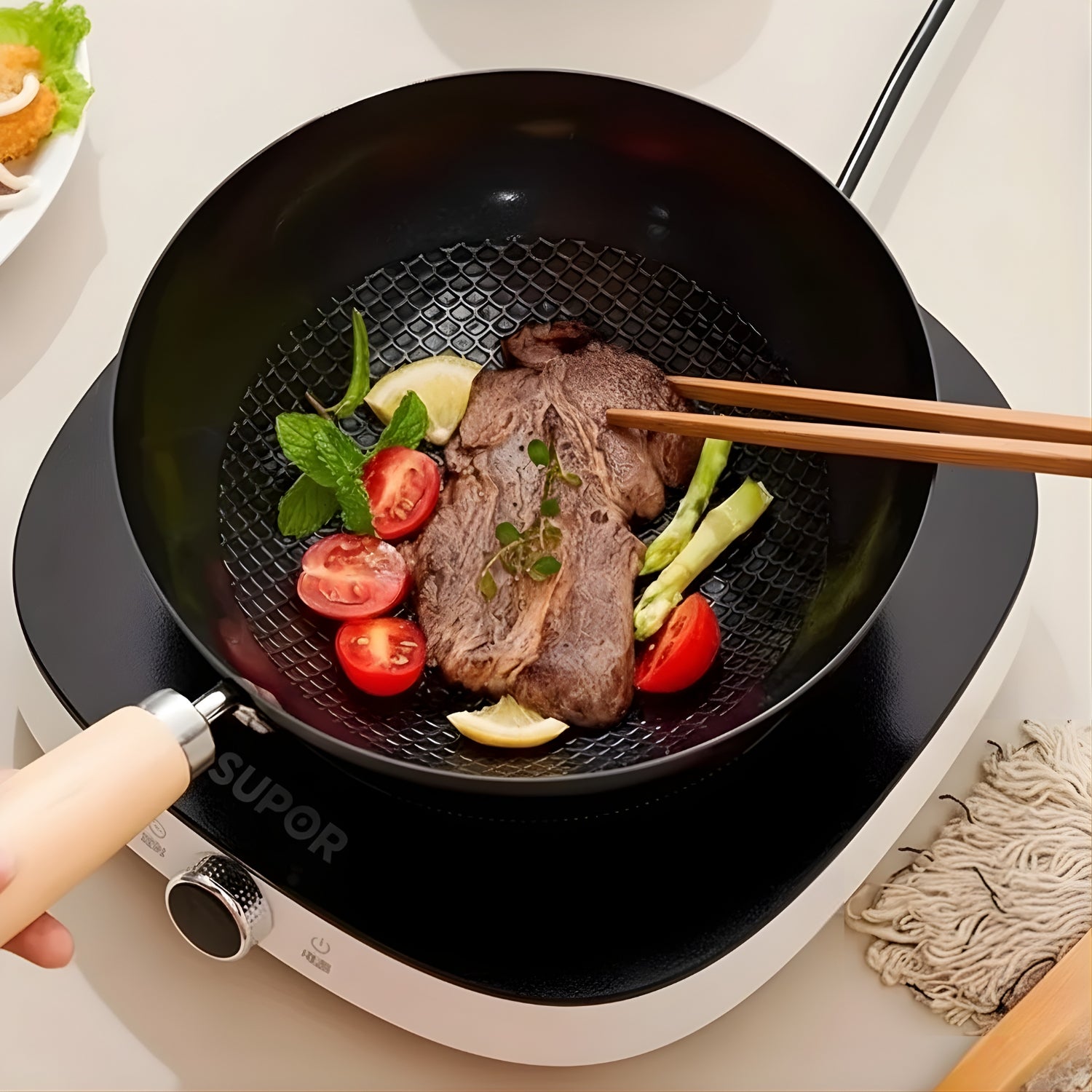 Frying pan with beef and vegetables on a Supor cooktop
